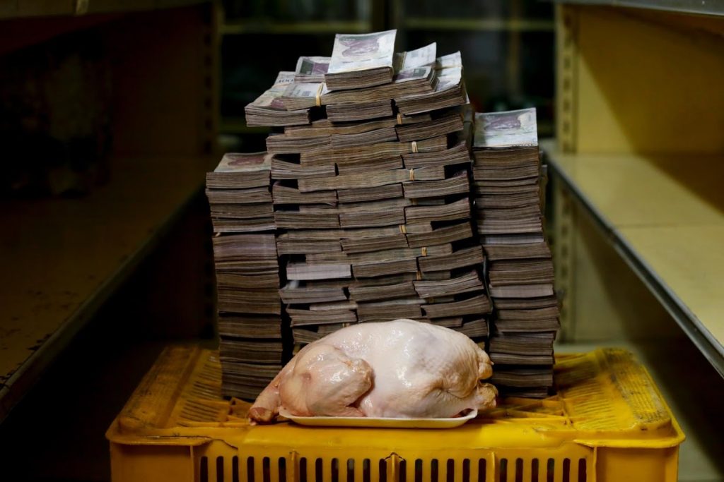 Chicken next to a pile of bank notes